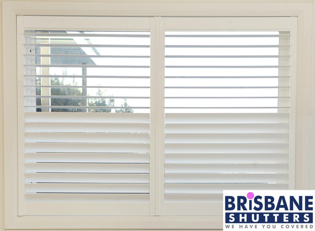 Close up of white plantation shutters half open