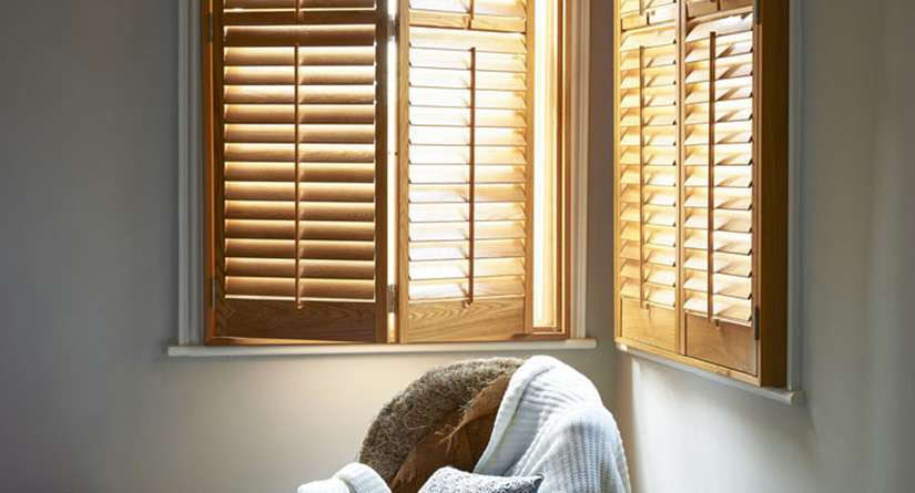 Stained timber shutters on adjacent walls