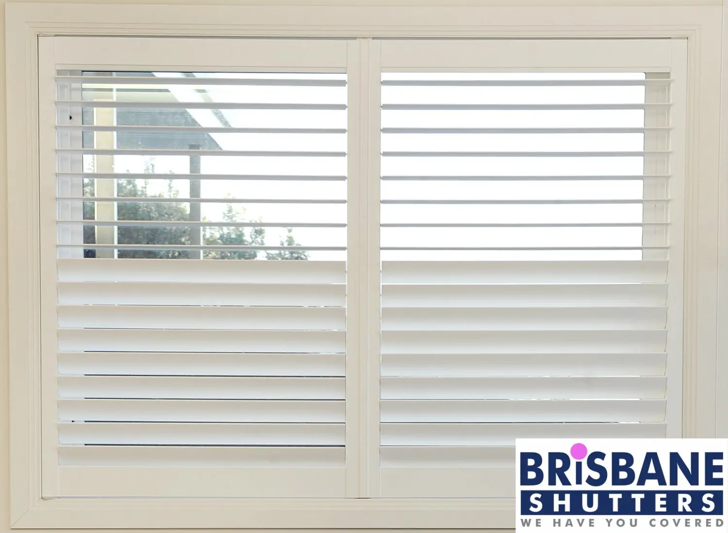 White plantation shutters with top half open