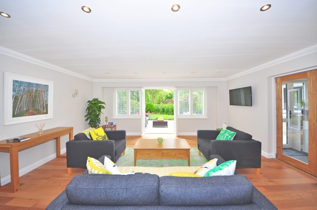 Widescreen view of living room with plantation shutters