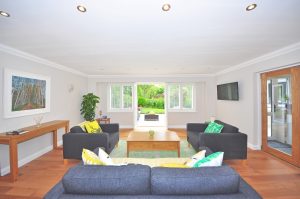 Widescreen view of living room with plantation shutters