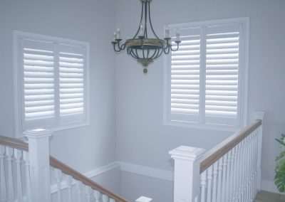 Plantation shutters installed above stair case