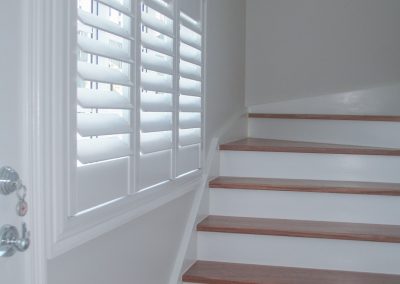 staircase view with plantation shutters