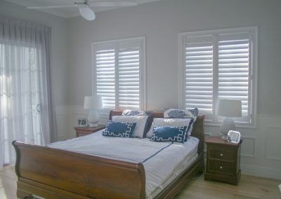 White plantation shutters installed in master bedroom
