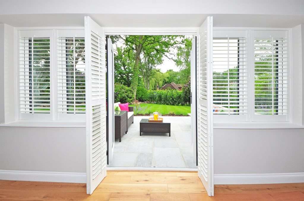 Open door way with plantation shutters on doors and windows