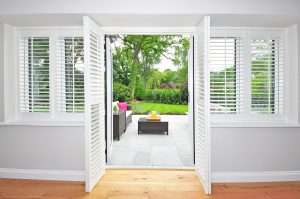 Open door way with plantation shutters on doors and windows