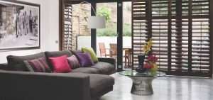 Wooden shutters on sliding doors in living area