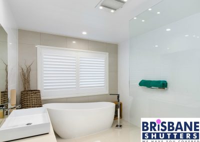 White plantation shutters in modern bathroom